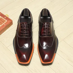 Top view of shiny burgundy leather Oxford shoes with square toe and orange sole accents