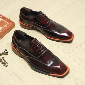 Macro view of glossy burgundy leather oxford shoes with stylish orange sole detail
