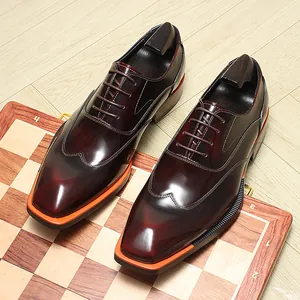 Close-up detail of glossy burgundy leather Oxford dress shoes on a chessboard base