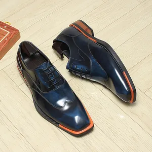 Detailed view of polished blue gradient men's Oxford shoes with orange sole edge trim.