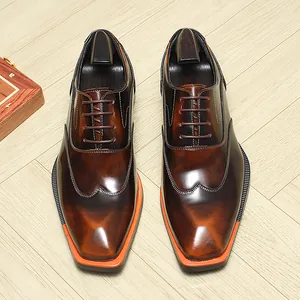 Premium brown leather Oxford shoes for men featuring unique orange soles and a glossy finish.