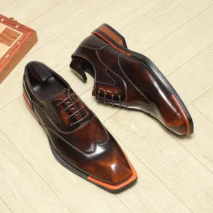 Close-up of brown gradient men's oxfords with unique square toe and orange welt
