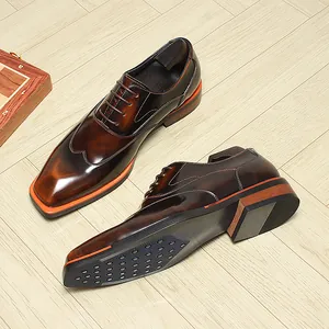 Detailed view of burnished brown leather Oxford shoes with stylish orange sole accents