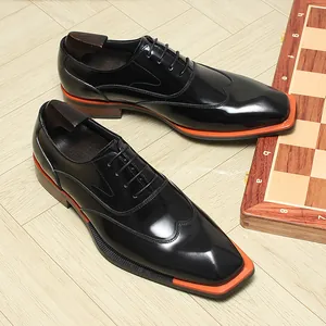 Black patent leather wingtip Oxford shoes with orange square-toe accent