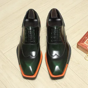 Detailed top view of men's shiny green Oxford shoes with square toe and orange sole.