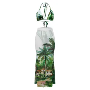 Detailed view of three-piece tropical print bikini set with matching mesh maxi skirt