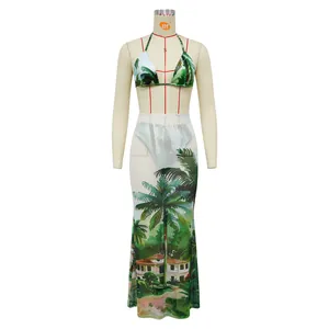 Three-piece bikini set featuring tropical landscape print and mesh maxi skirt