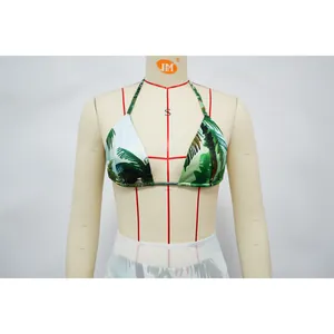 Detailed macro view of a sexy tropical palm leaf print bikini top on a tailor mannequin