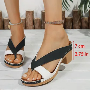 Close-up of black and white chunky heel thong sandals featuring a 7cm/2.75in heel height