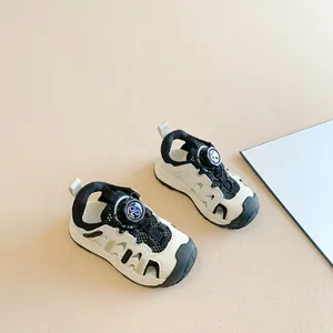 Stylish black and white kids' closed-toe sandals with easy dial-up knob closure system
