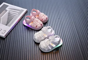 Kleinkind Mädchen Blumensandalen mit LED-Leuchtsohlen auf dunklem Grund