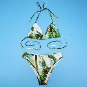 Top view of a two-piece bikini featuring a tropical green palm leaf print on blue