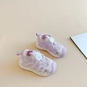 Macro view of lavender children's closed-toe sandals featuring white mesh and rotary button