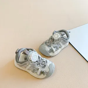 Stylish silver kids' closed-toe sandals with adjustable rotary button closure.