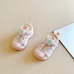 Detail of pink children's closed-toe sandals featuring a convenient rotary dial lace system