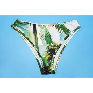 Detail view of tropical palm leaf print bikini bottoms with high-leg cut