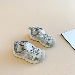 Detail of children's silver closed-toe sandals with rotating buckle lace system