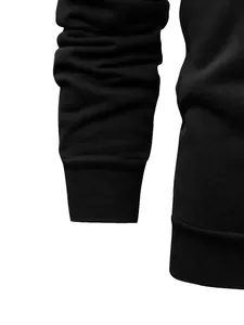Close-up of black fleece hoodie showing sleeve cuff and ribbed hem material detail
