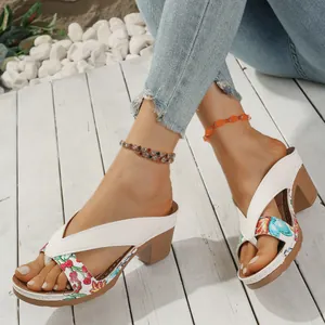 Close-up of floral fabric and white leather details on these stylish women's sandals