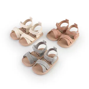 Multiple pairs of infant summer sandals featuring soft cross straps in various colors