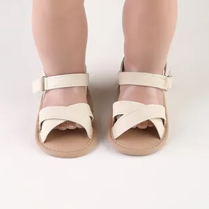 Close-up detail of cream baby summer sandals for infants and first walkers aged 0-1 year old