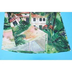 Detail of mesh fabric hem on tropical landscape print beach cover-up skirt