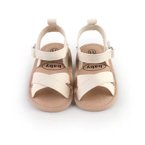 Cream-colored baby summer sandals with cross-straps and velcro closure for toddlers