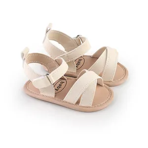 Detailed view of cream baby sandals featuring cross-strap design and soft toddler soles