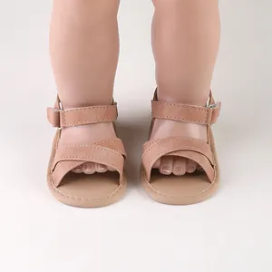 Close-up detail of soft-soled baby summer sandals with elegant dusty rose cross straps.