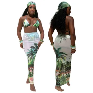 Three-piece women's swimwear set with tropical palm print bikini and sarong skirt