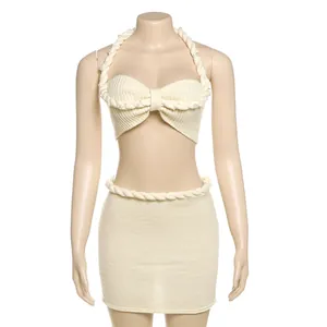 Completo chic in maglia crema con top all'americana con perle e minigonna abbinata