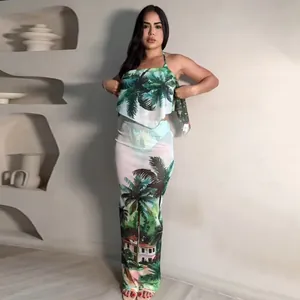 Two-piece tropical palm print beach set featuring a halter top and slim maxi skirt