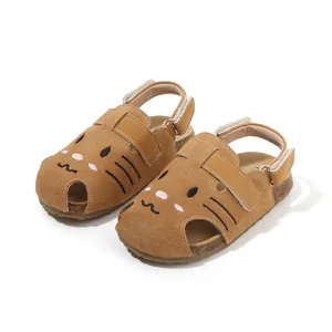 Adorable brown suede toddler sandals featuring a cartoon cat face and closed-toe design