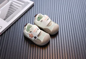 Detailed view of toddler breathable mesh sneakers with star strap and soft sole design.