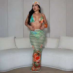 Detail view of tropical print bikini top and matching high-waisted beach maxi skirt