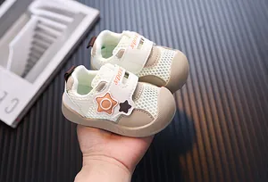 Detail of breathable mesh toddler walking shoes with star decoration and Velcro strap.