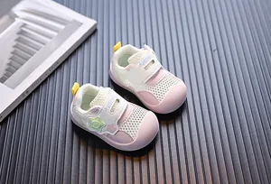 Detailed macro shot of breathable pink and purple mesh toddler walking sneakers for summer