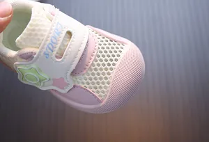 Close-up of pink breathable mesh toddler shoes with floral detail for summer wear