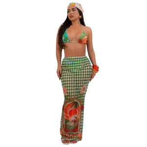 Detailed view of the vibrant tropical graphic print on the long beach skirt and bikini set