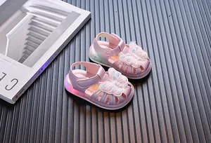 Pink and purple LED light-up toddler sandals with butterfly embroidery decoration.