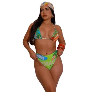 Detailed view of sexy tropical print bikini set with green beach graphics