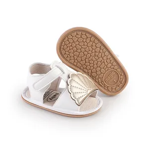 White baby summer walking sandals featuring gold shell decoration and anti-slip rubber sole