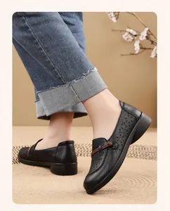 Close-up detail of black breathable hollow-out leather loafers for elderly women