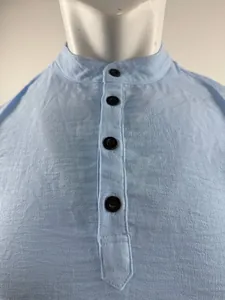 Detailaufnahme des hellblauen Henley-Shirt-Kragens mit schwarzen Knöpfen