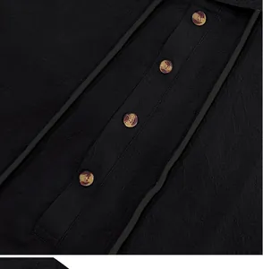Close-up detail of black breathable linen Henley shirt with stylish amber buttons