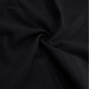 Detailed macro view of the breathable black linen fabric texture on a men's shirt