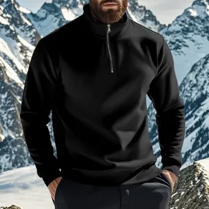 Detailed view of a men's black half-zip sweatshirt with a stand collar in the snow