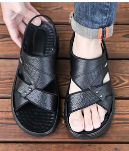 Primer plano de sandalias de cuero negro para hombre con grano texturizado y correa
