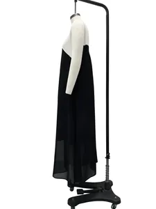 Detailed side view of a loose black and white spliced sleeveless maxi dress on mannequin