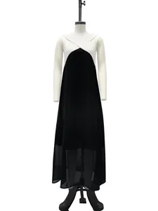 Detail view of a sleeveless black and white color-block maxi dress on a mannequin